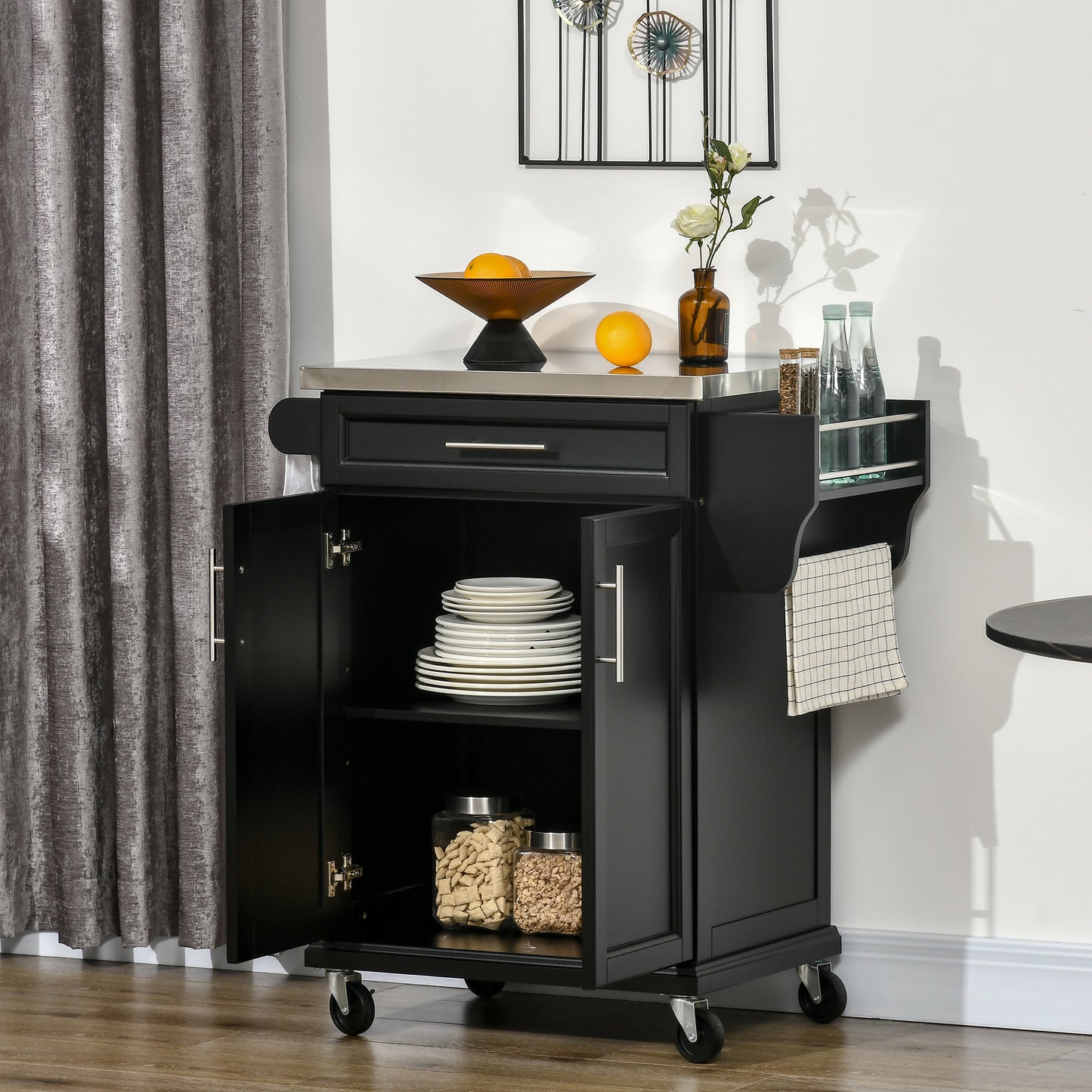 Black kitchen island cart with stainless steel top and open cabinets showing plates and canisters
