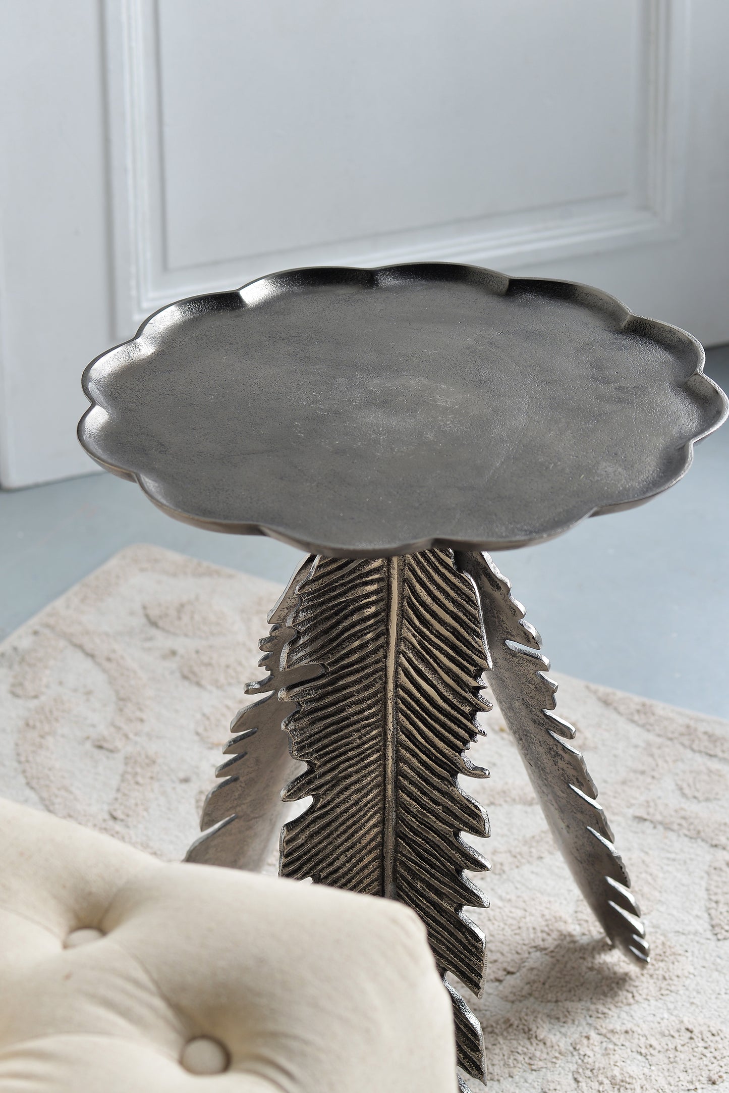 Antique silver side table with decorative scalloped edge and leafshaped legs