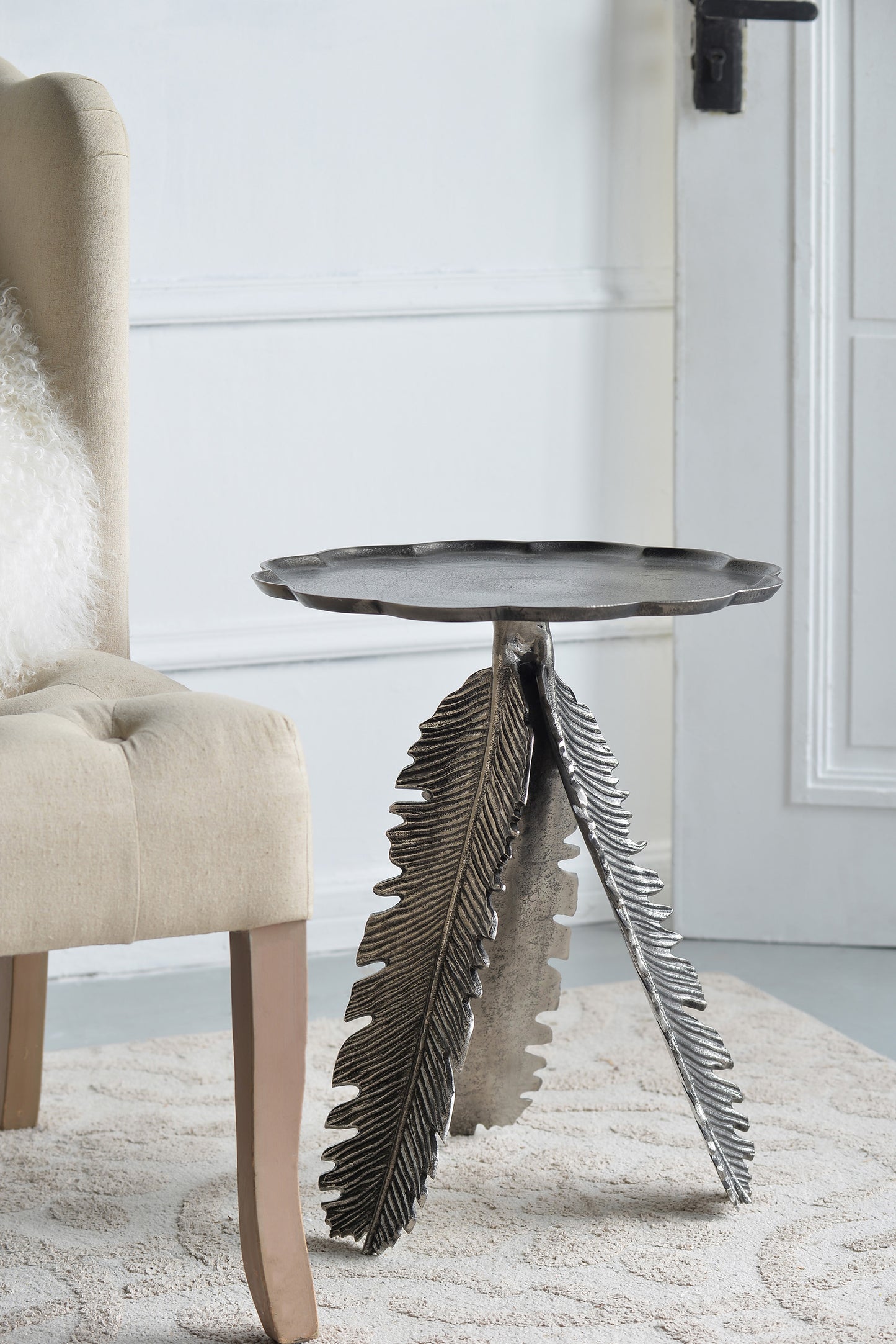 Antique silver metal side table with detailed feather legs ideal for living rooms