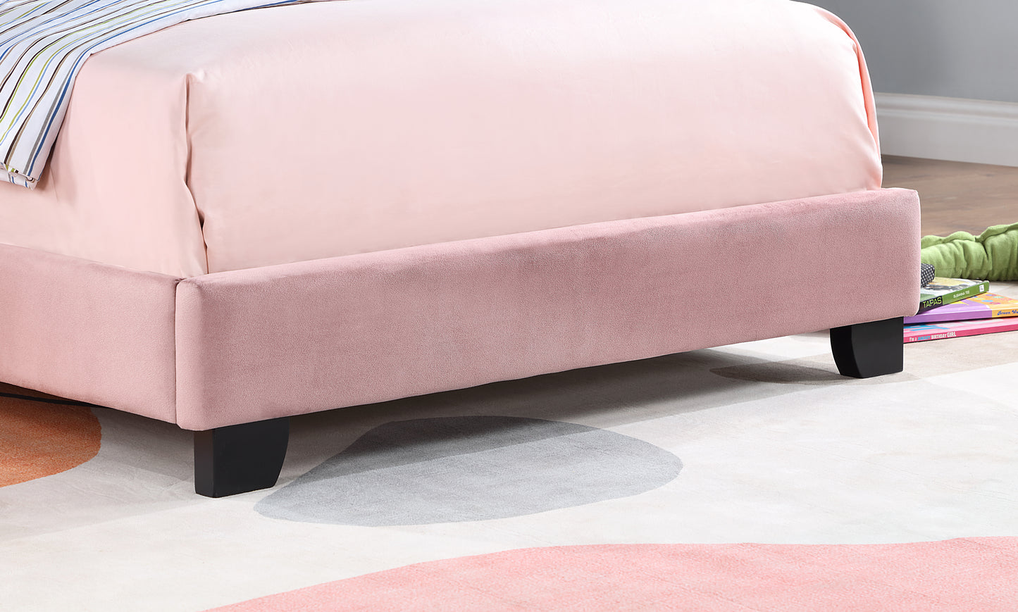Pink velvet bed frame with black wooden legs