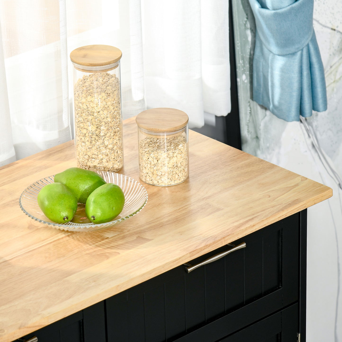 Clear glass canister with bamboo lid filled with rolled oats