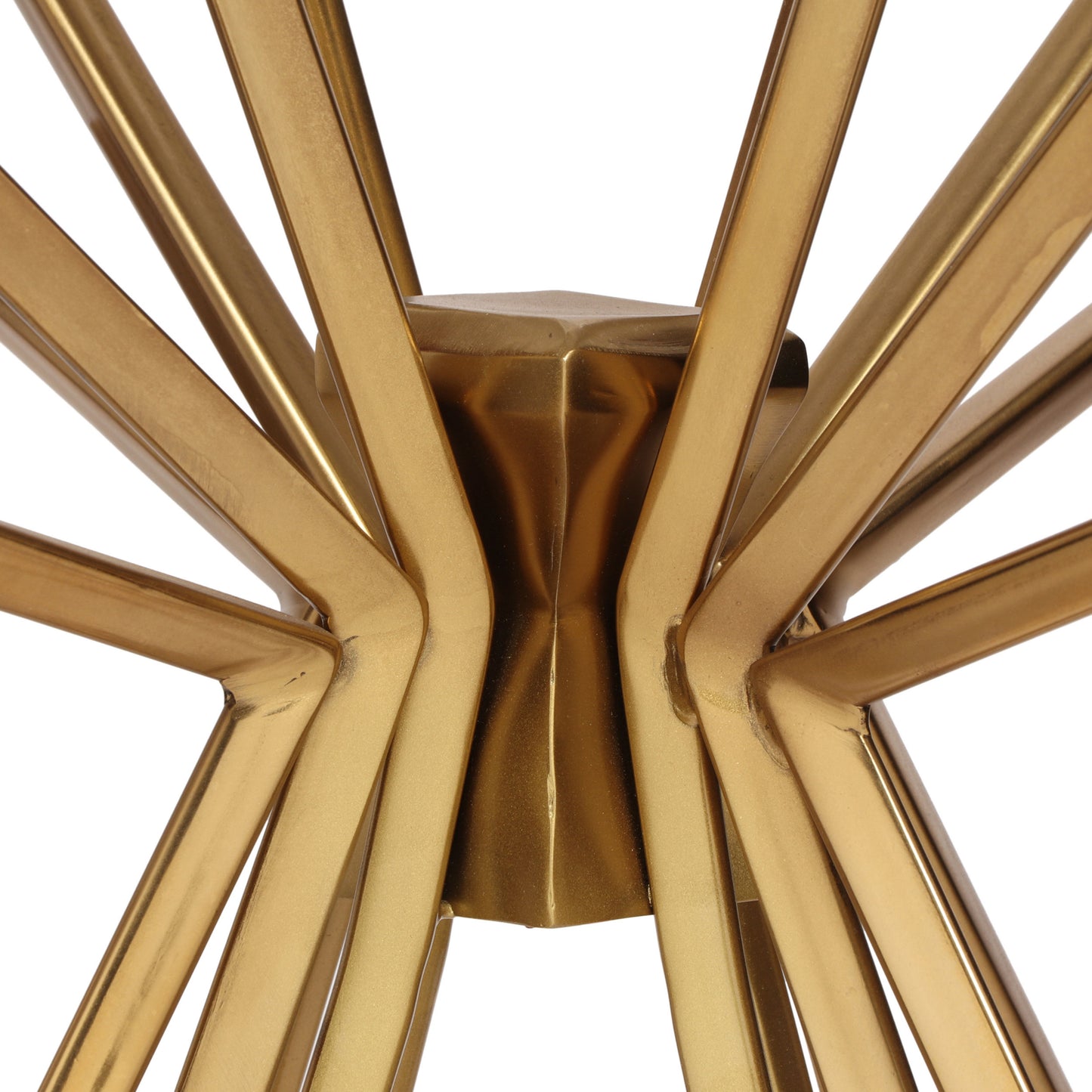 Closeup of a golden metal starburst base for a modern accent table