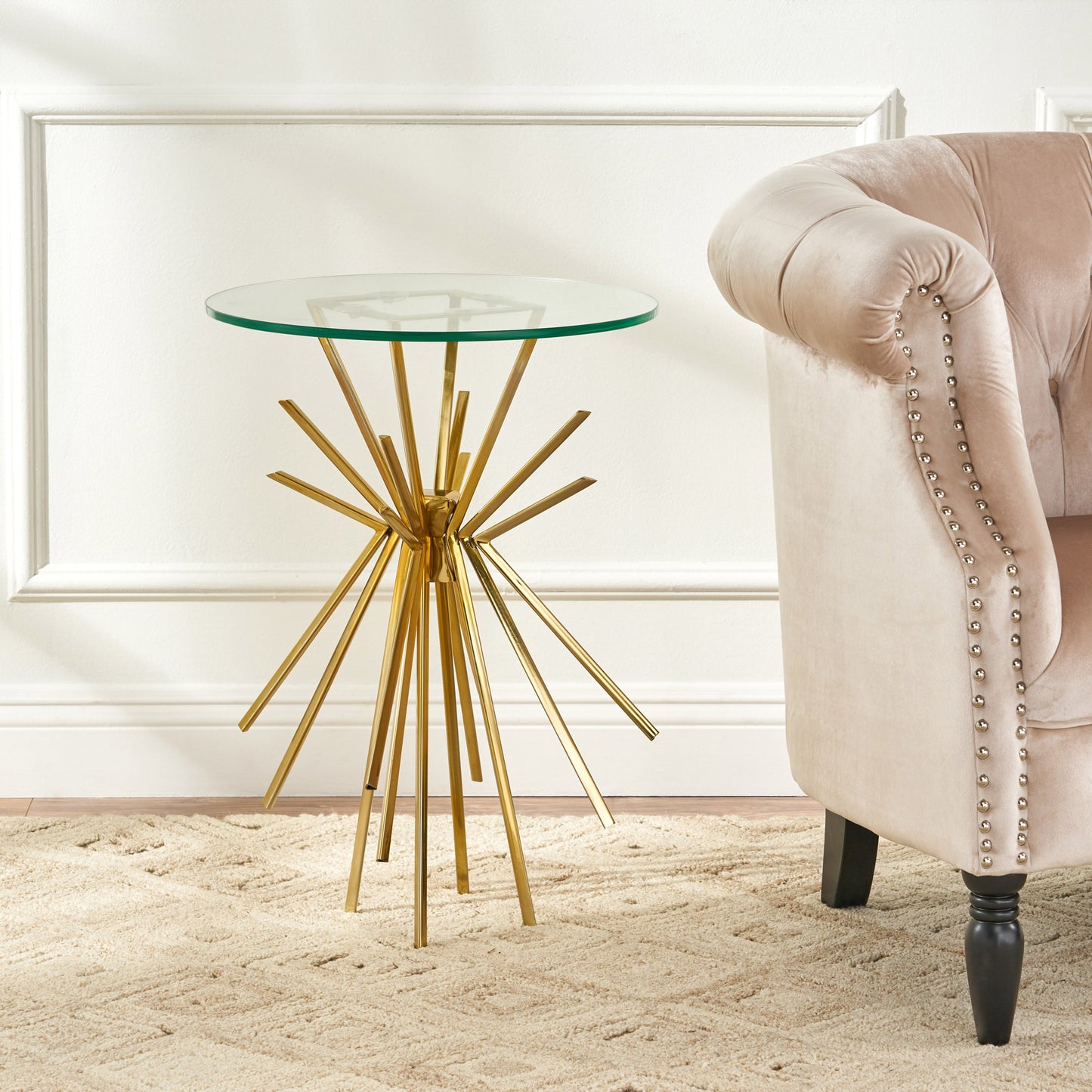 Gold starburst base side table with a clear glass top for modern living rooms