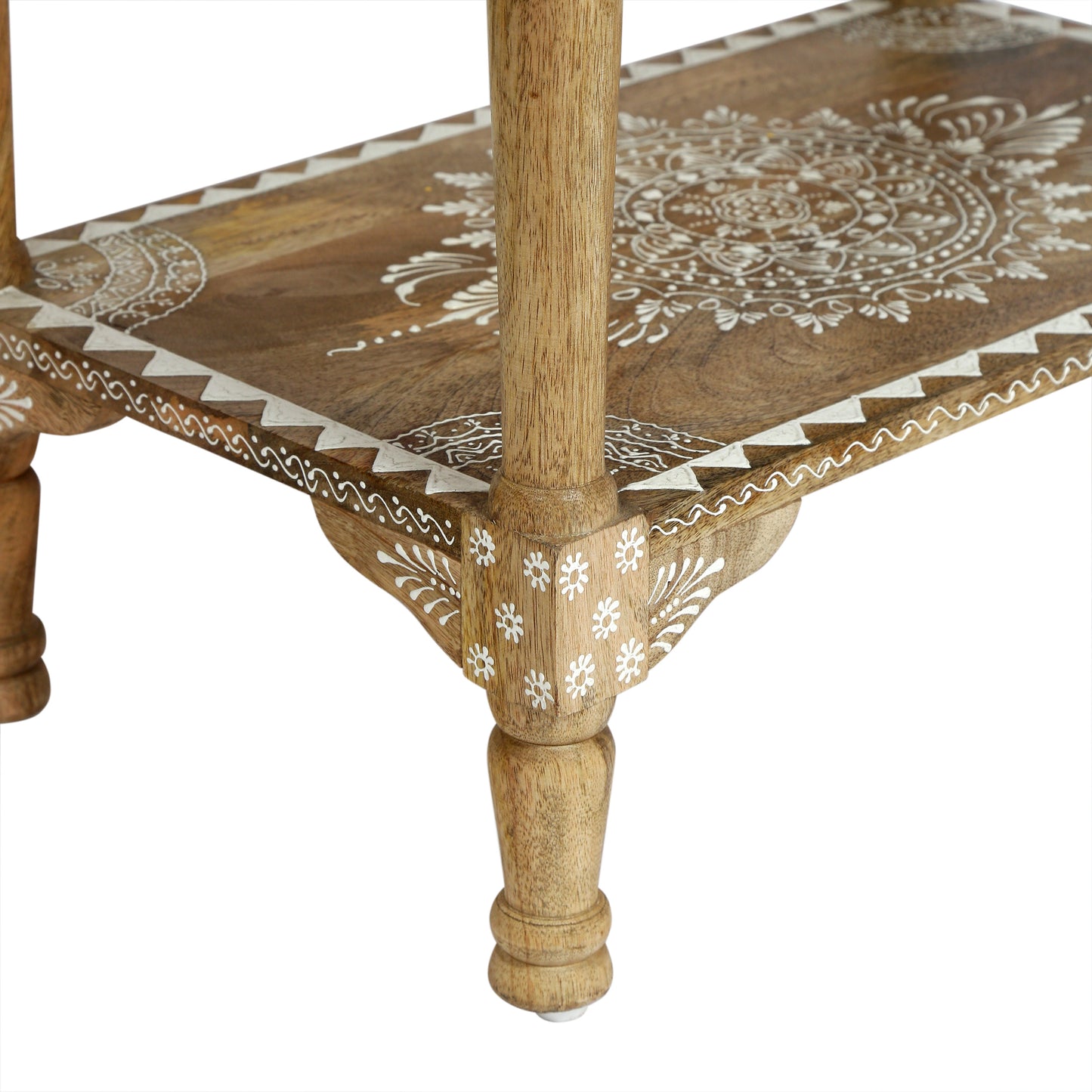 Closeup of carved mango wood side table with white mandala pattern inlay