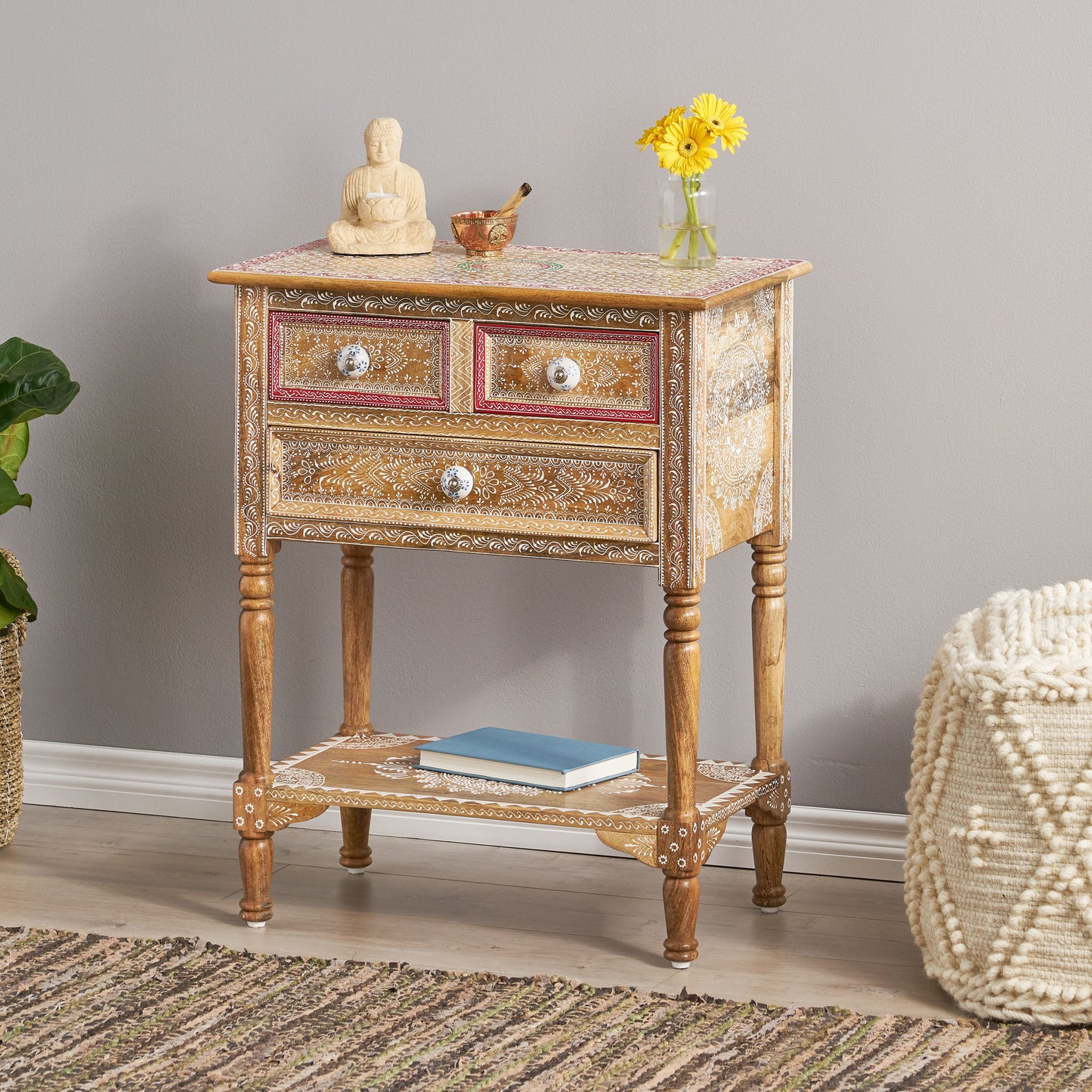 Distressed mango wood accent table with handpainted white floral details and three drawers