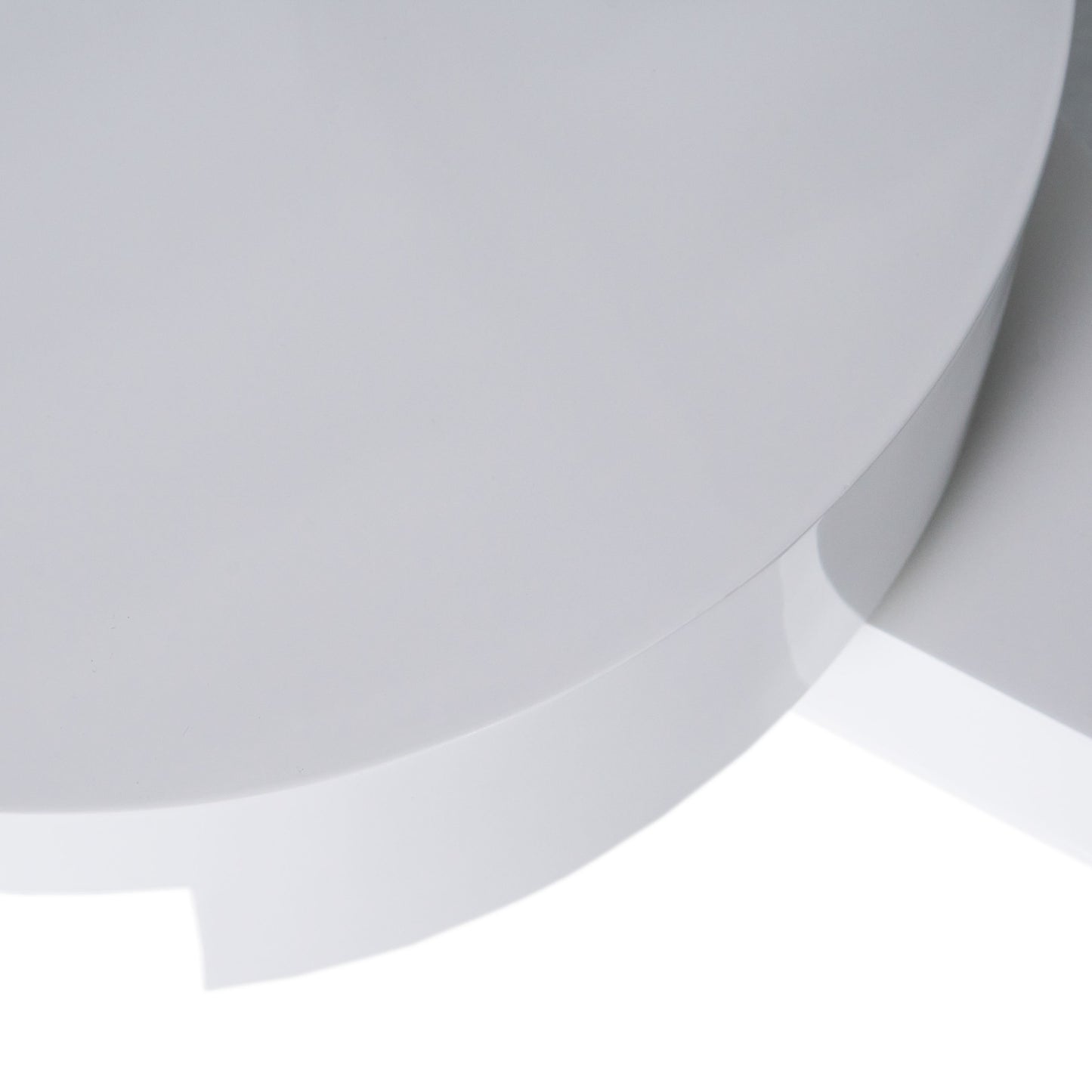 Closeup of a smooth white circular ceramic planter with a subtle gloss finish