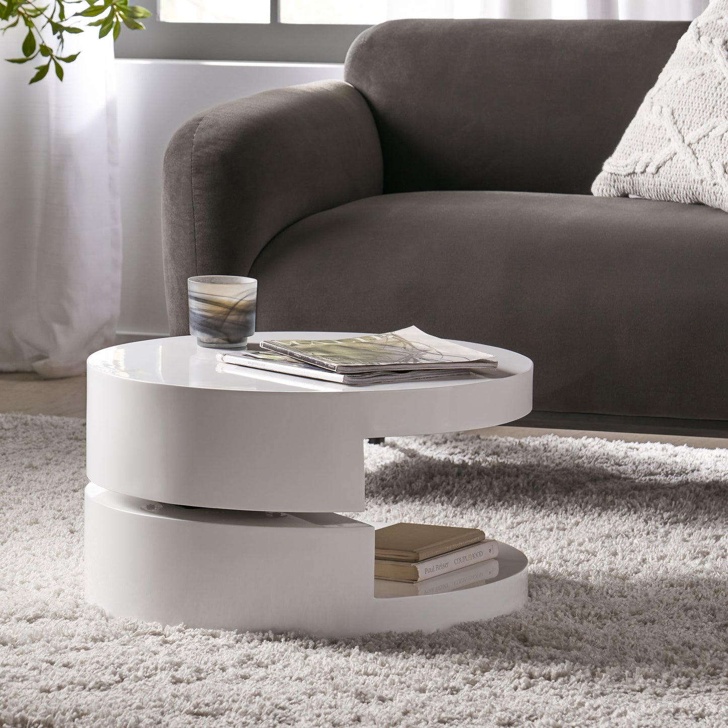 Modern white gloss nesting coffee table with magazines and books