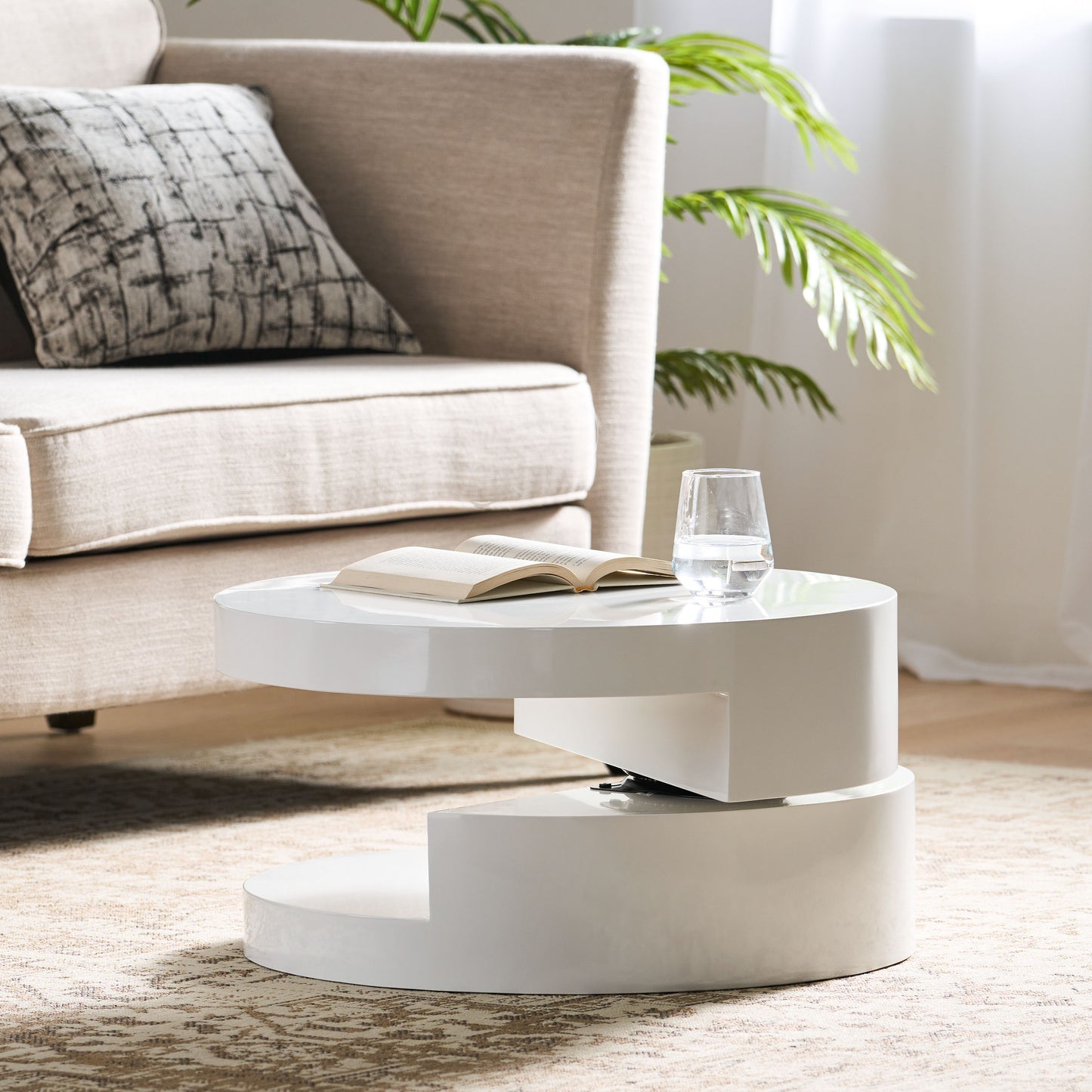 White contemporary coffee table with open book and glass of water