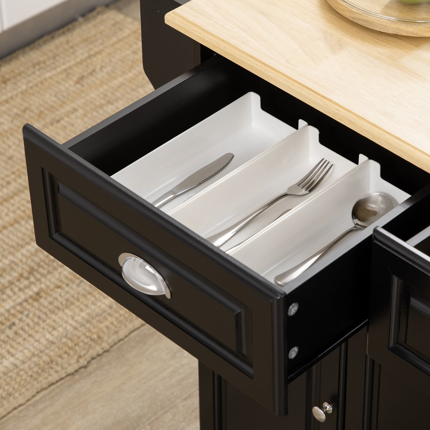 Black kitchen island drawer with silverware organizer and utensils