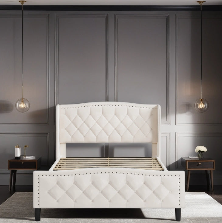 Cream velvet upholstered platform bed frame with diamond tufting and nailhead trim