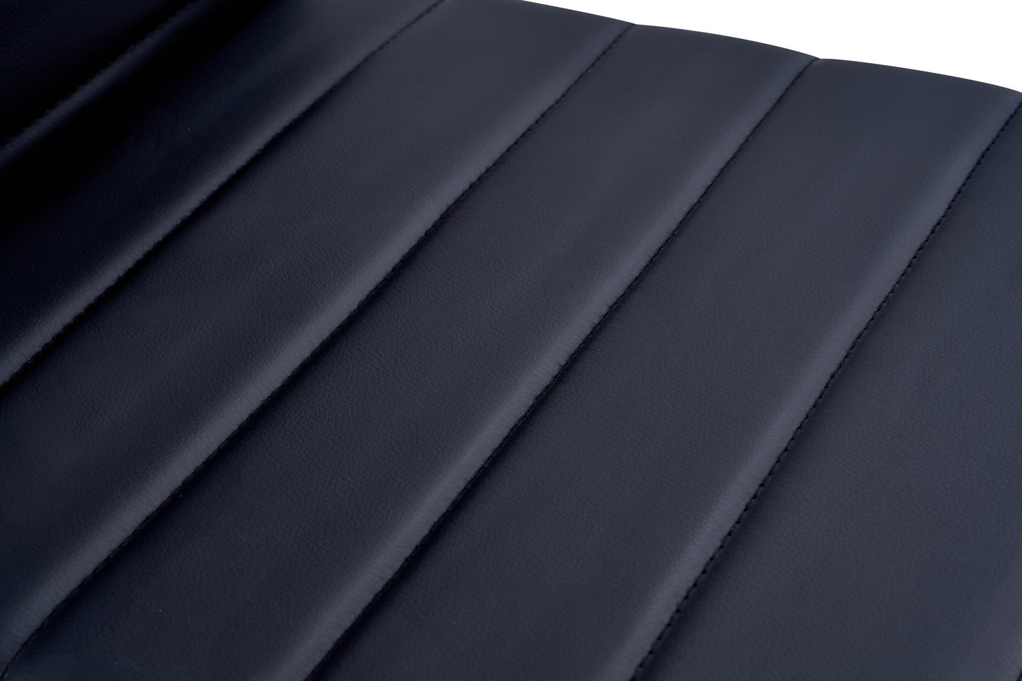 Closeup of navy blue faux leather with channel tufting