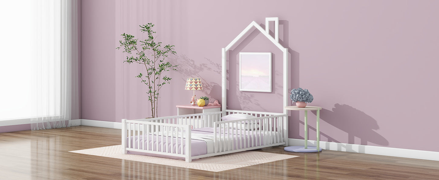 White wooden toddler bed with pastel bedding and a houseshaped frame