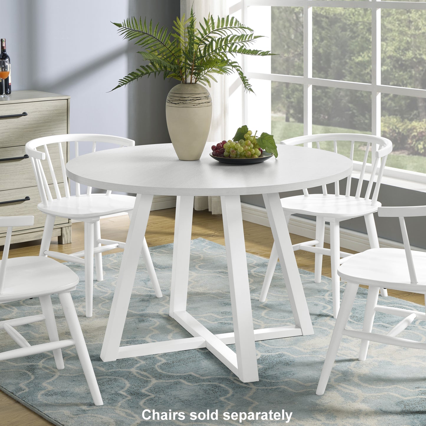 Round white dining table with slatted back chairs