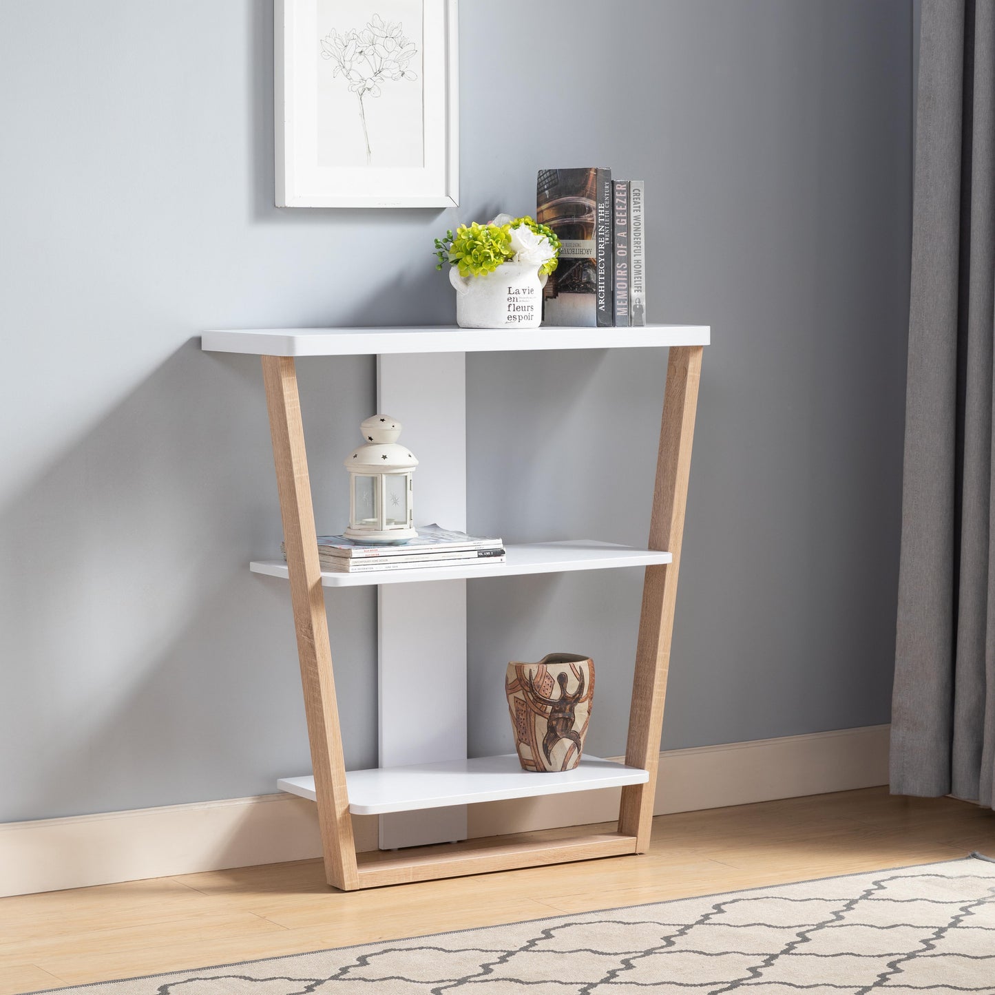 White and wood accent console table with three shelves and decorative items