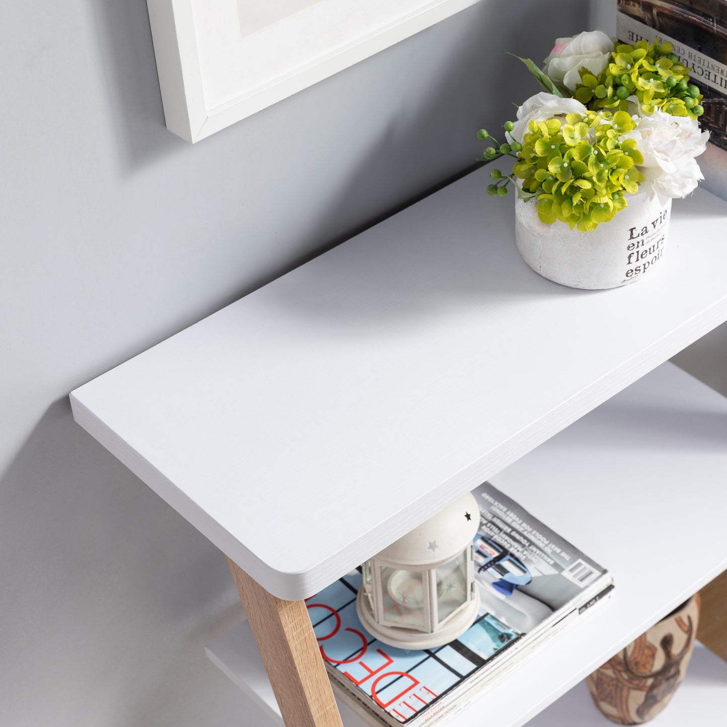 White modern shelf with decorative vase and books