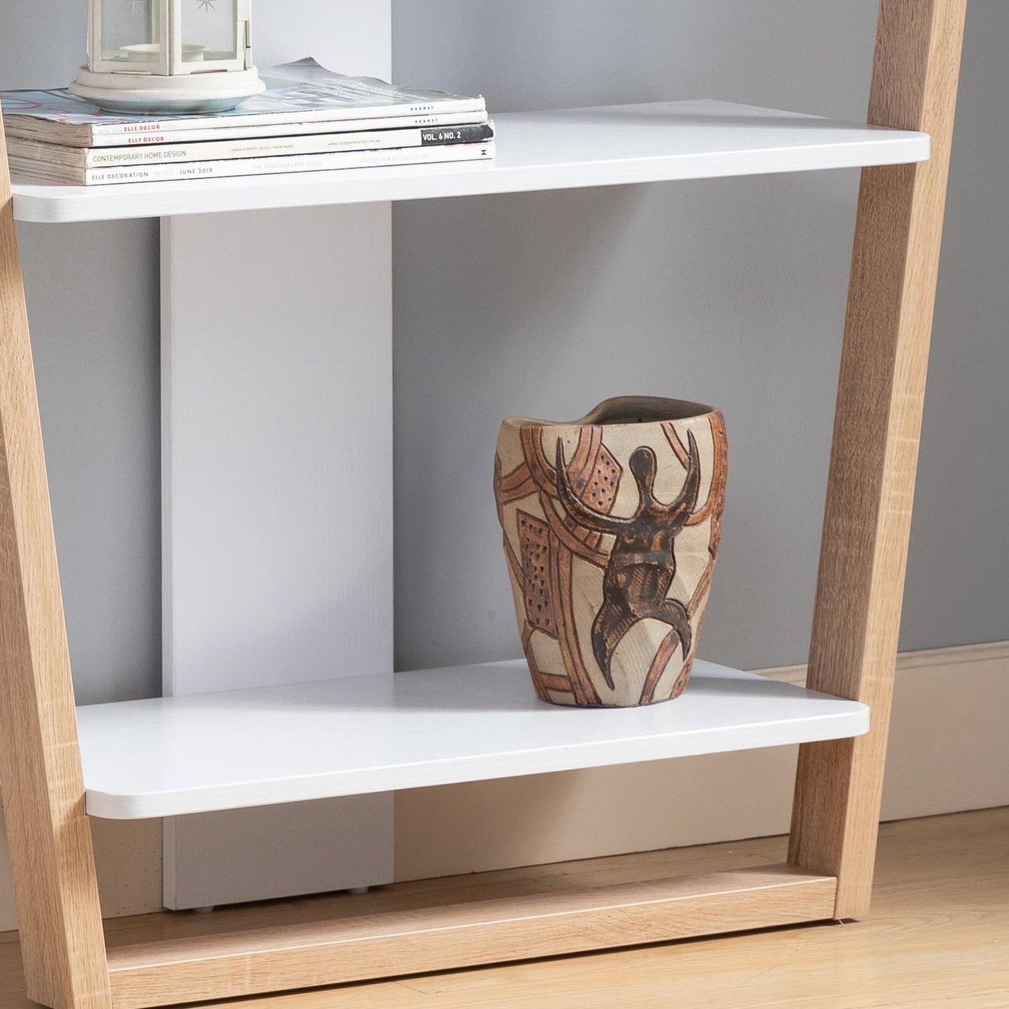 Decorative ceramic vase with a tribal human figure design a unique accent piece for shelves