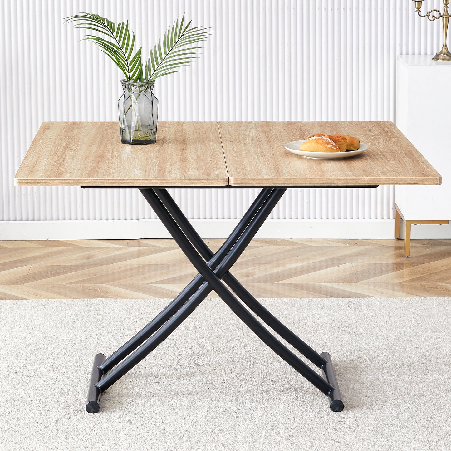 Light wood lift top coffee table with black metal crisscross legs