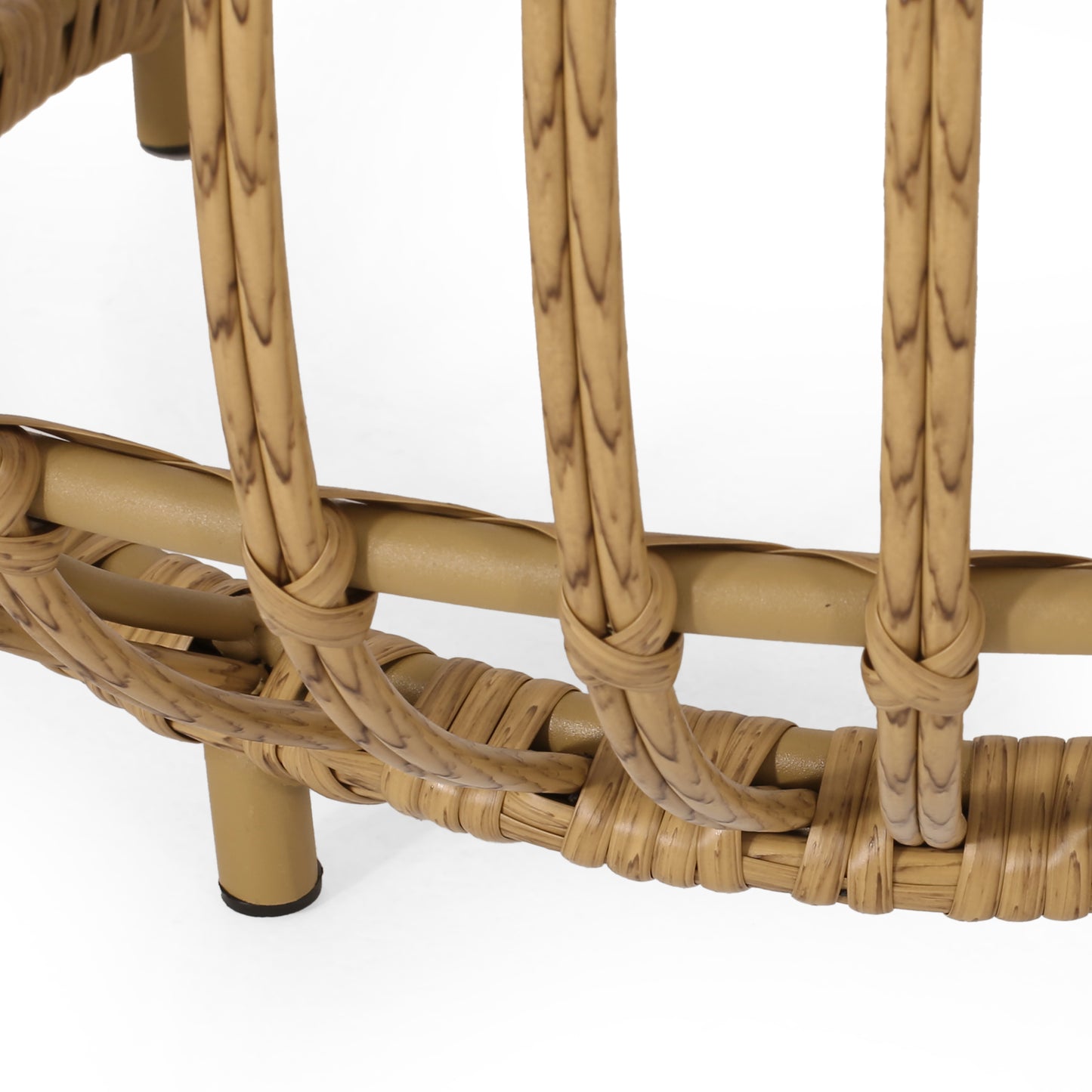Closeup of tan wicker furniture base with intricate weaving and sturdy legs