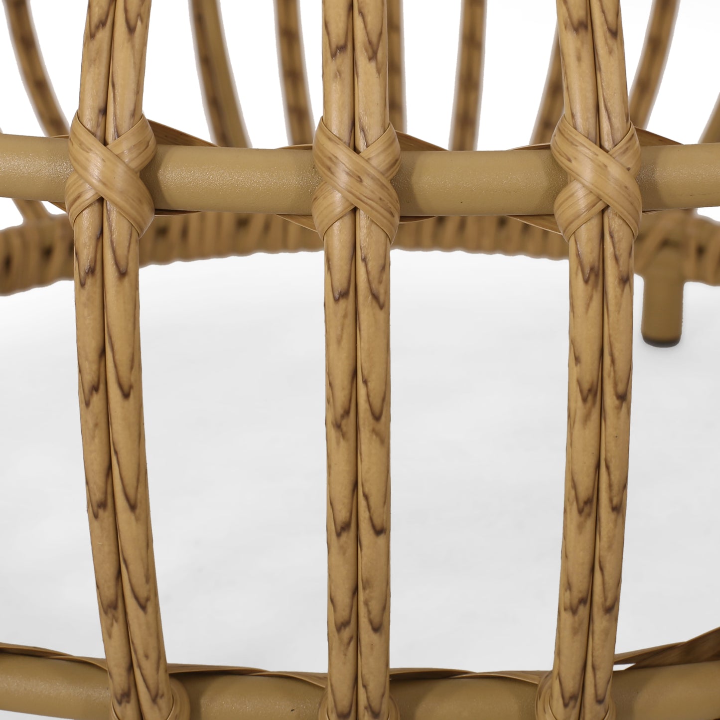 Detail of tan rattan chair frame with intricate weaving