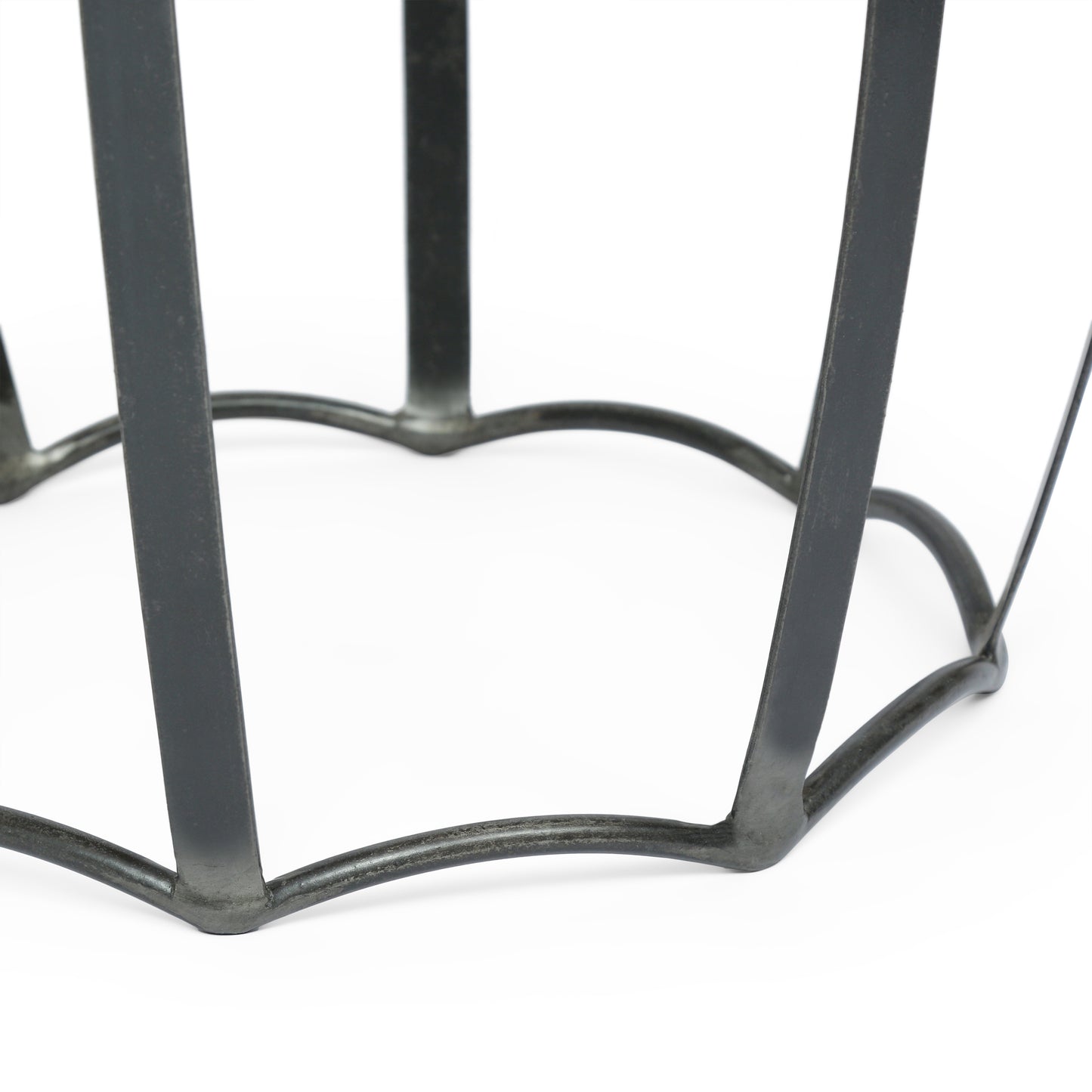 Dark gray metal table base with curved legs and a decorative geometric design
