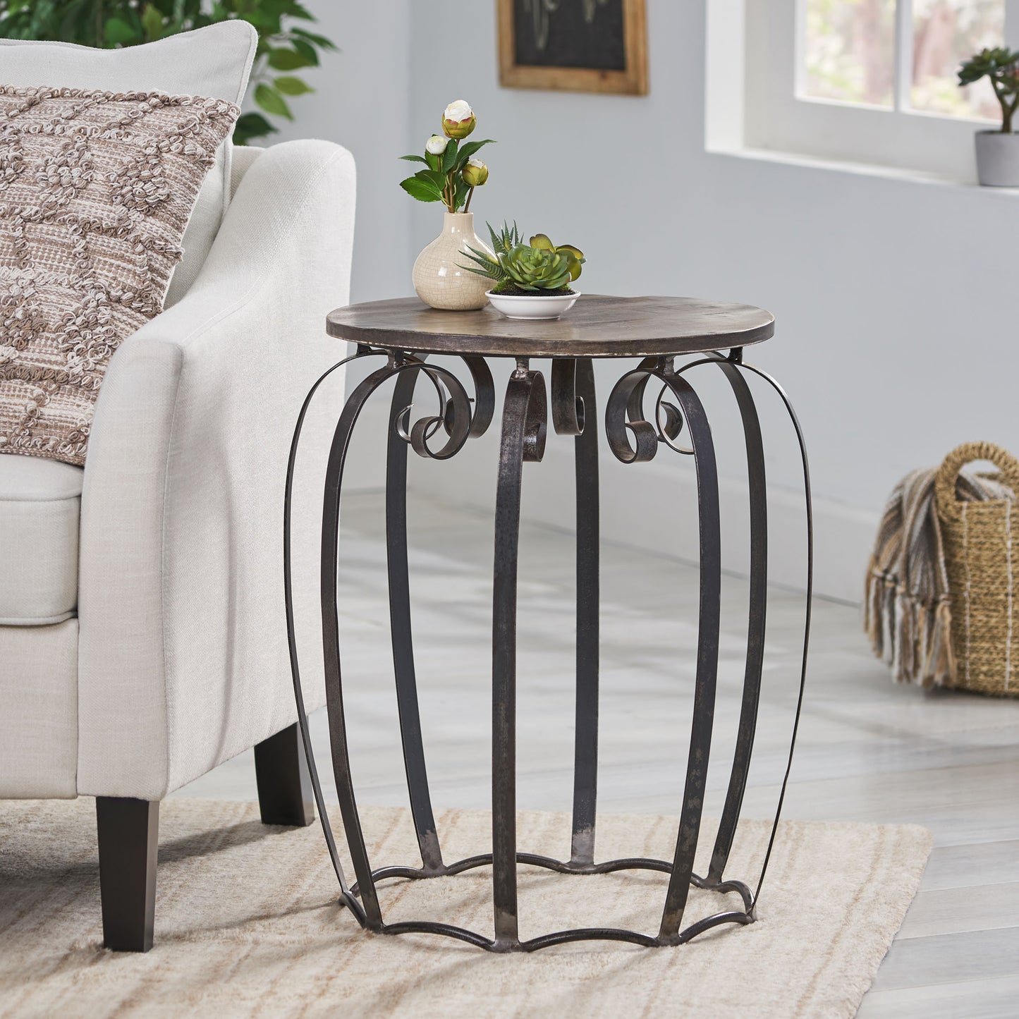 Round distressed wood top side table with ornate scrolled metal base perfect for living room decor