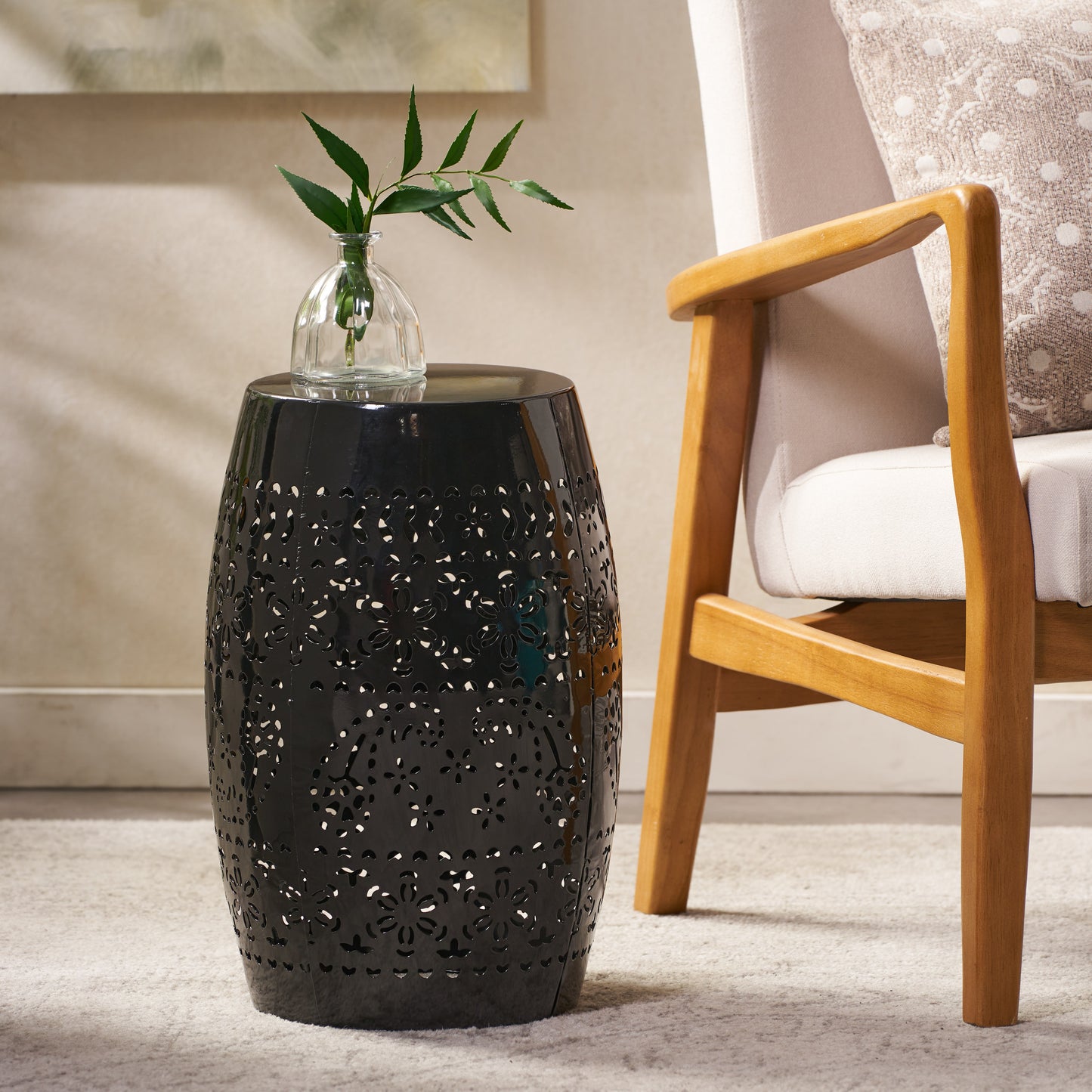 Black metal garden stool with floral cutouts perfect for indoor or outdoor use