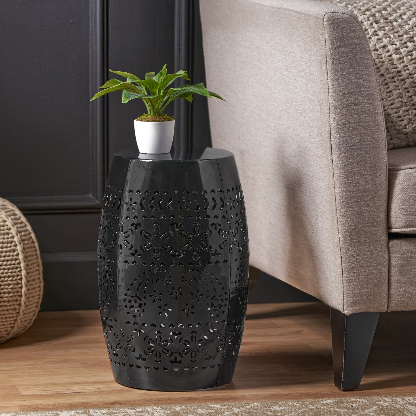 Black metal drum stool with intricate floral cutouts perfect for modern decor
