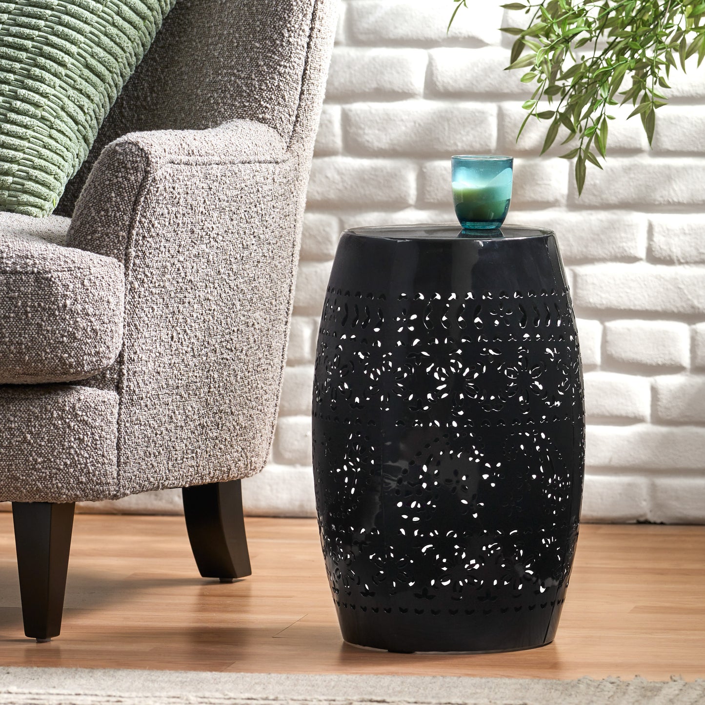 Black metal garden stool with intricate floral cutouts perfect for outdoor seating