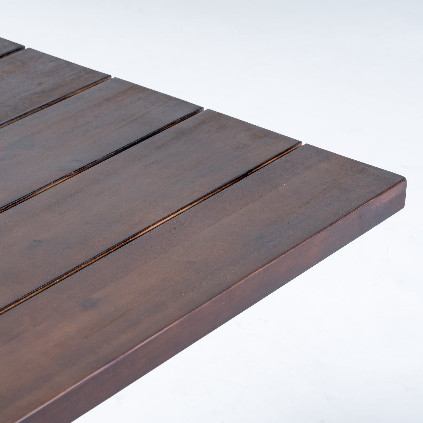Dark brown wooden slatted tabletop with a clean modern design for outdoor furniture