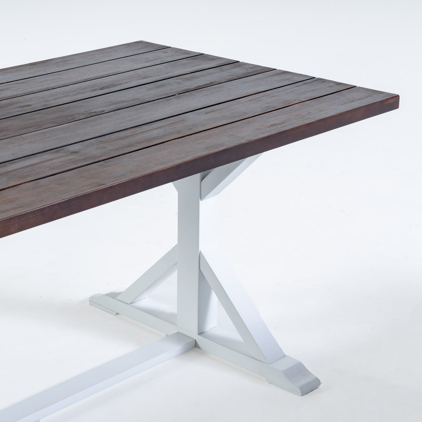 Dark wood plank dining table with white trestle base