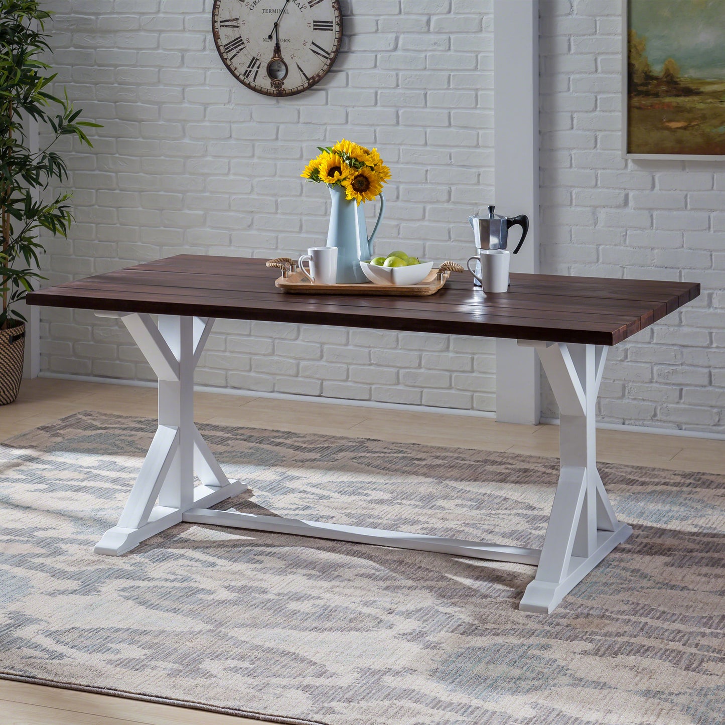 Dark wood plank dining table with white trestle base and modern farmhouse design
