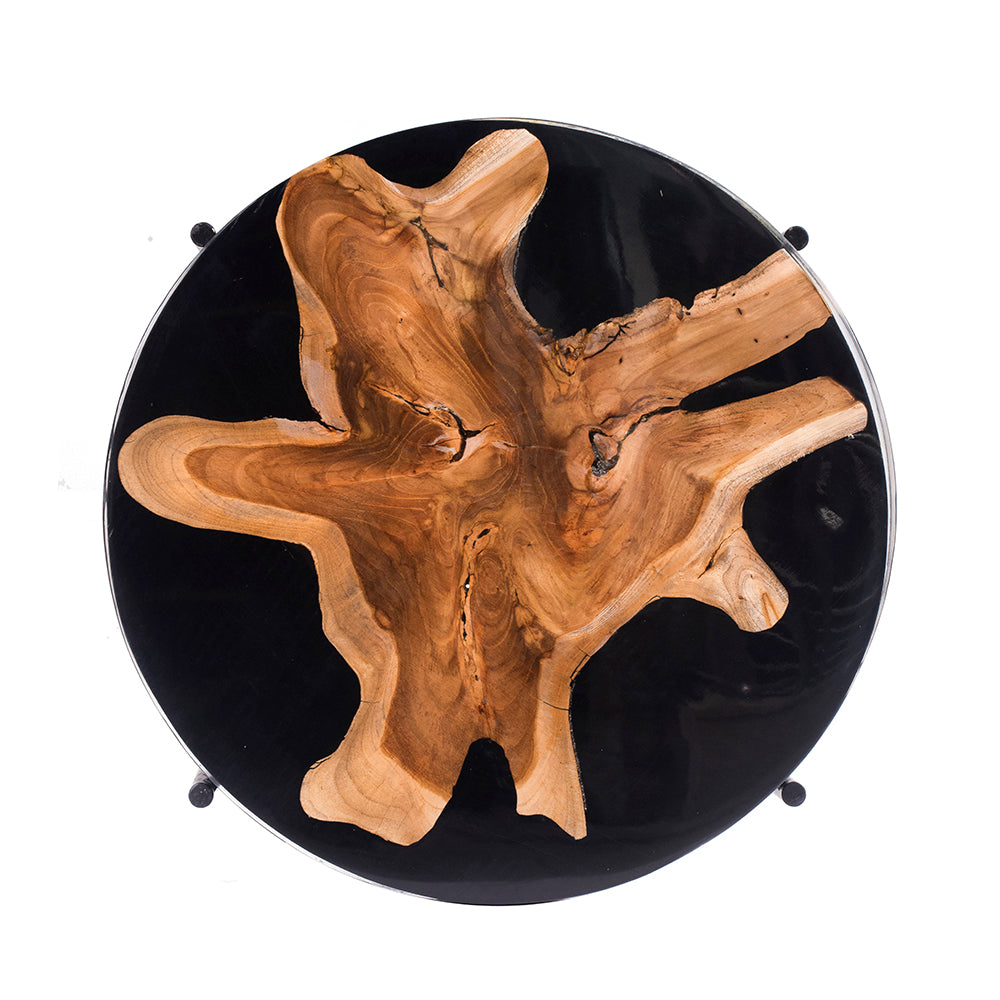Round wood slice coffee table with natural wood grain embedded in black resin