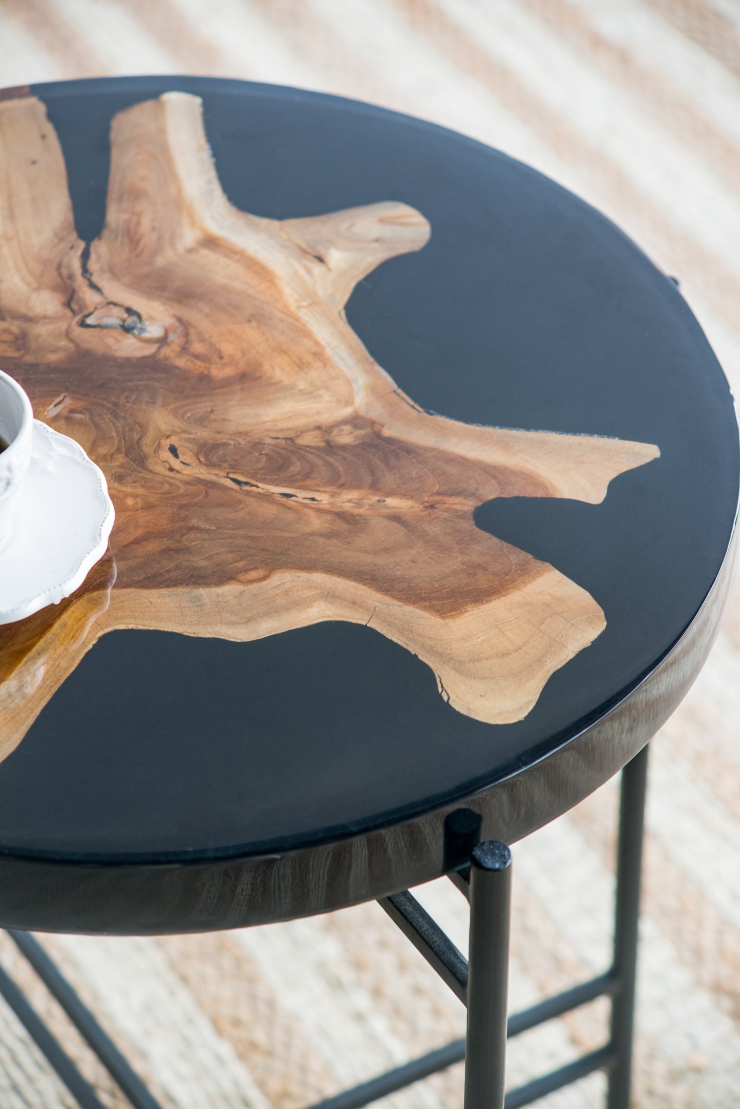 Rustic live edge coffee table with a natural wood slab embedded in black epoxy resin