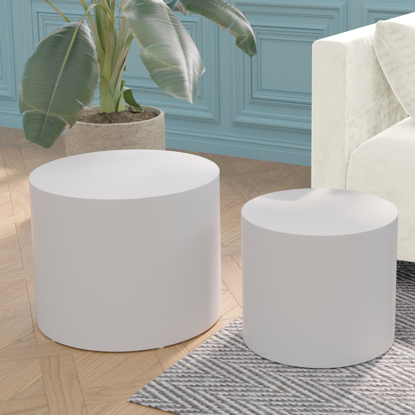 Pair of white cylindrical accent tables on a rug