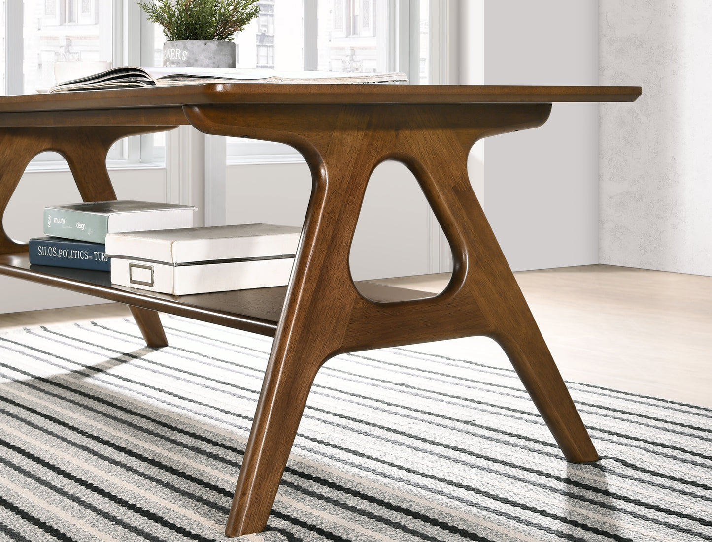 Midcentury modern walnut desk with unique cutout legs and a lower shelf