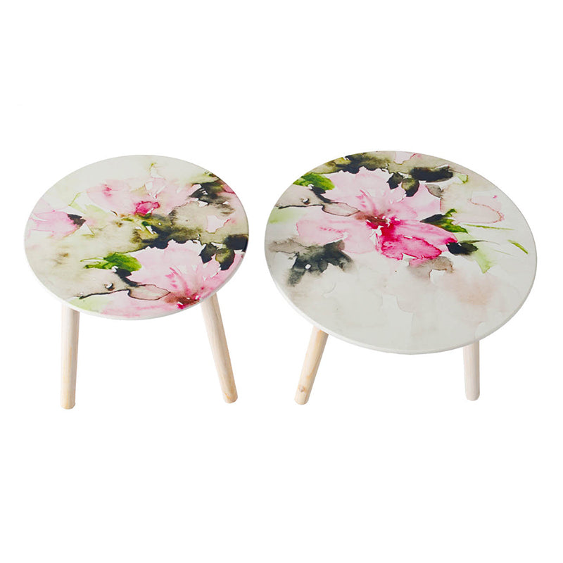 Two round accent tables with delicate pink floral watercolor print and wooden legs