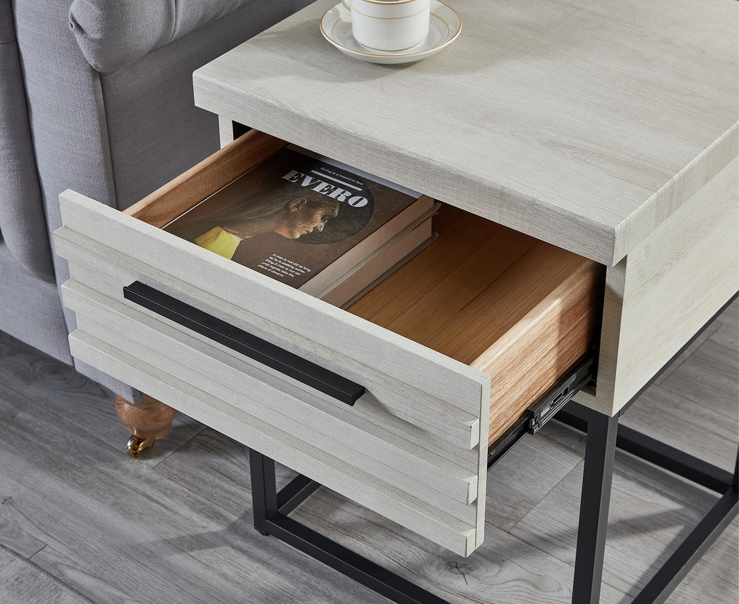 Light wood grain end table with one open drawer and a black handle