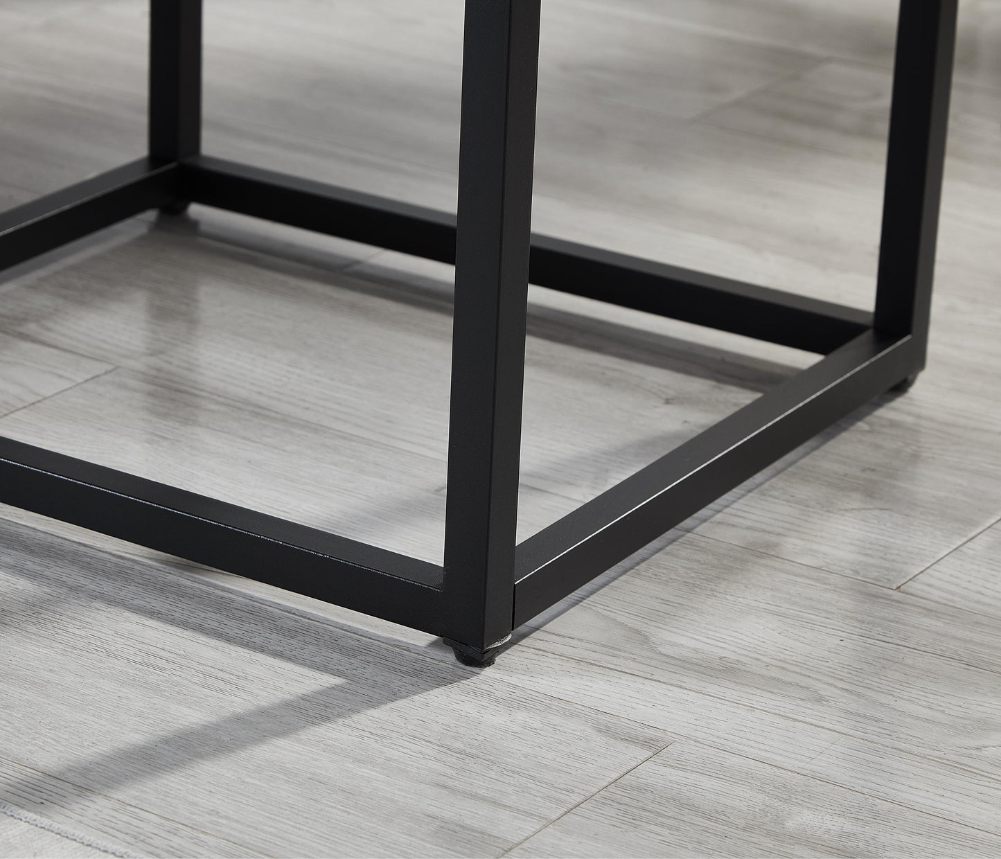 Black metal table legs with modern design on light wood floor