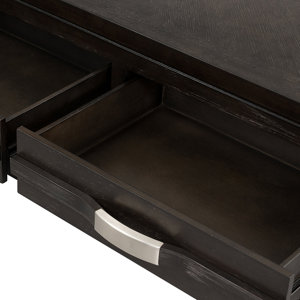 Dark wood dresser drawer with silver pull handle showing interior storage