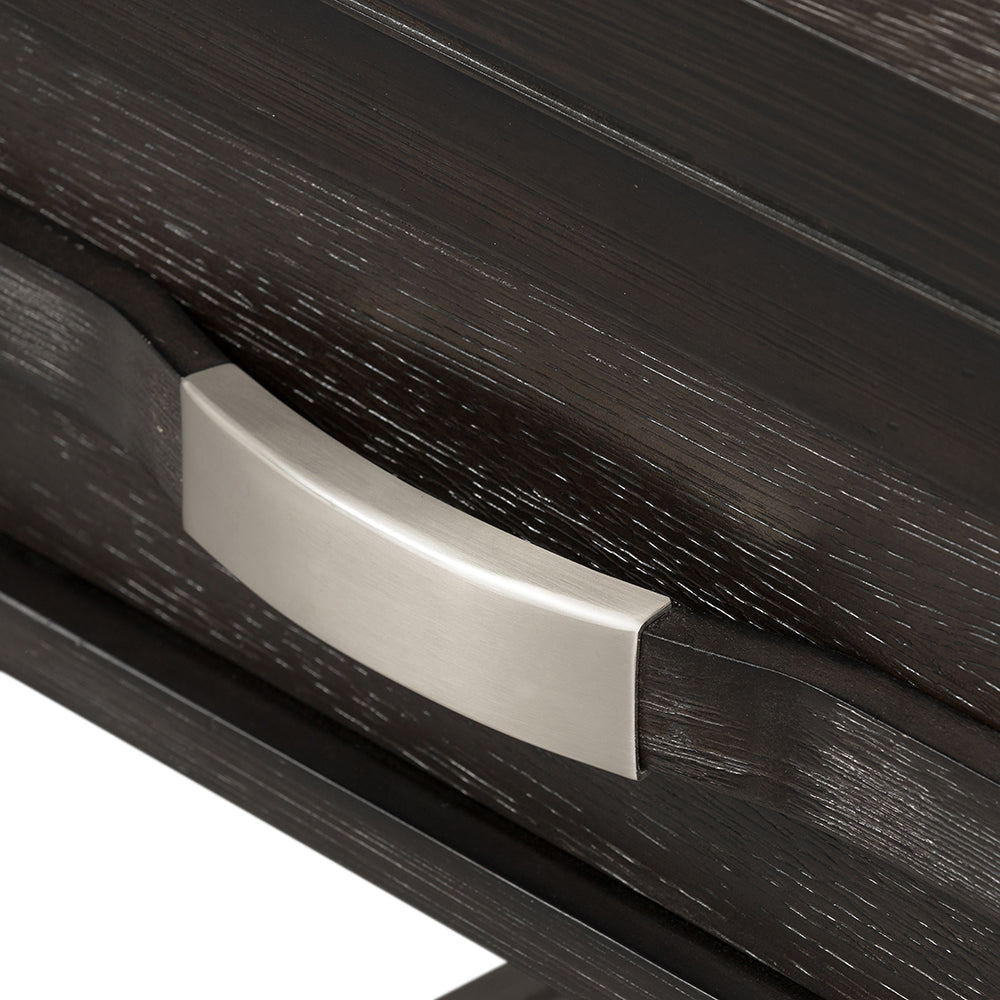 Closeup of a dark wood dresser drawer with a brushed nickel handle