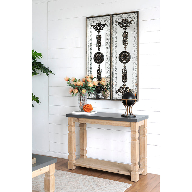 Distressed antique silver panel mirror with ornate black scrollwork and central medallions