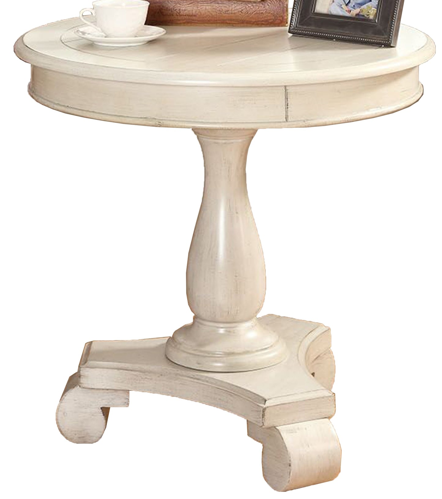 Distressed ivory pedestal accent table with carved legs and a round top