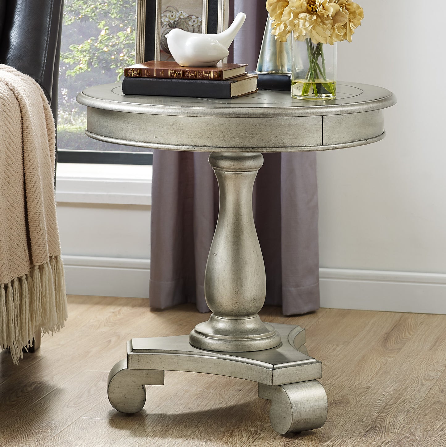Antique silver round accent table with carved pedestal base and decorative drawer