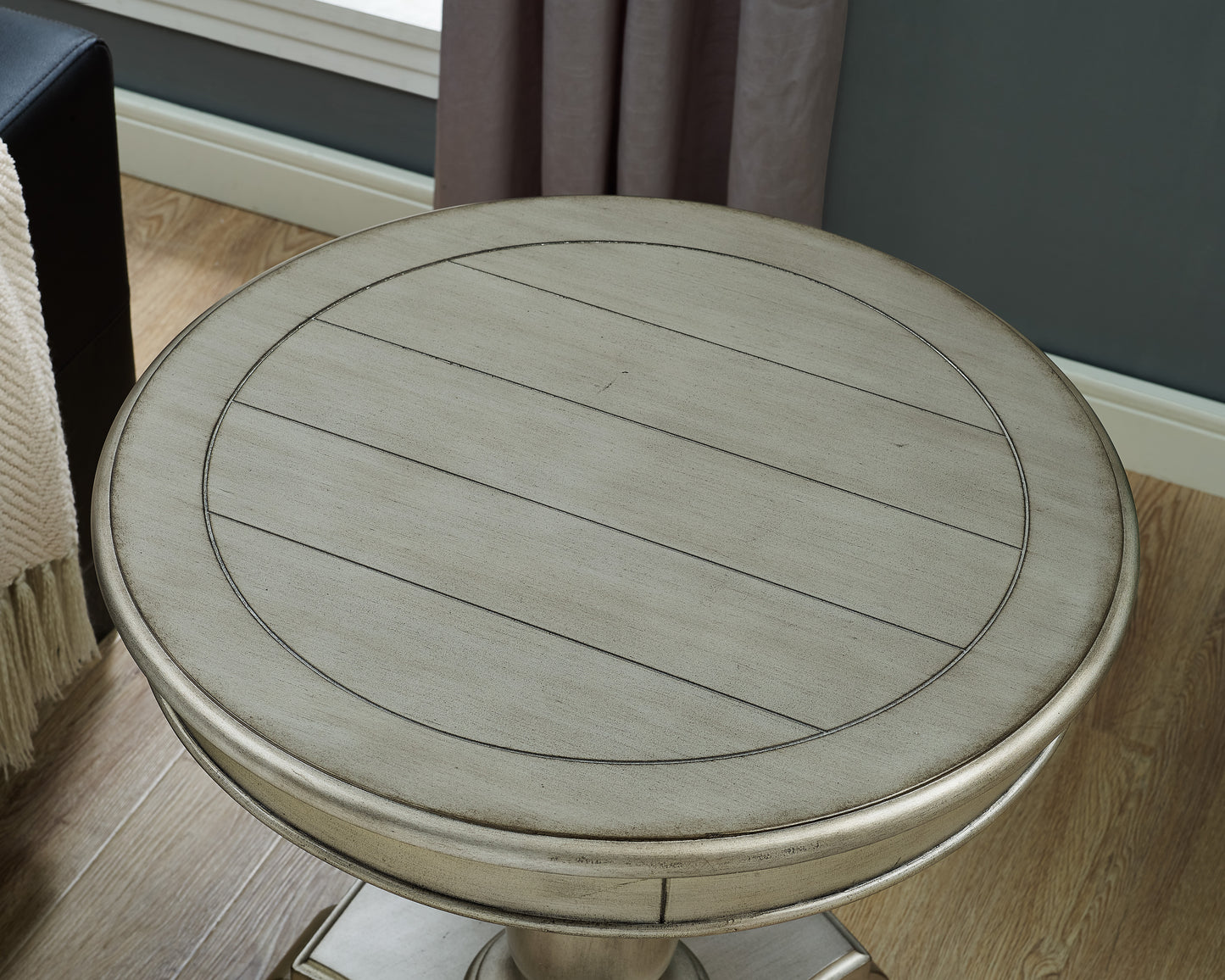 Antique white round accent table with planked wood top and ornate pedestal base