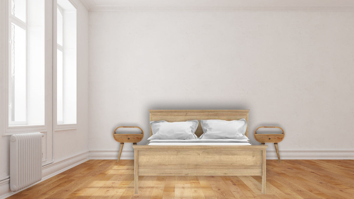 Light oak wood bed frame with white bedding and two matching oval nightstands