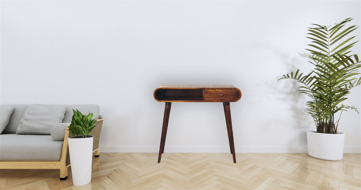Round entryway table with a single drawer in warm wood tones