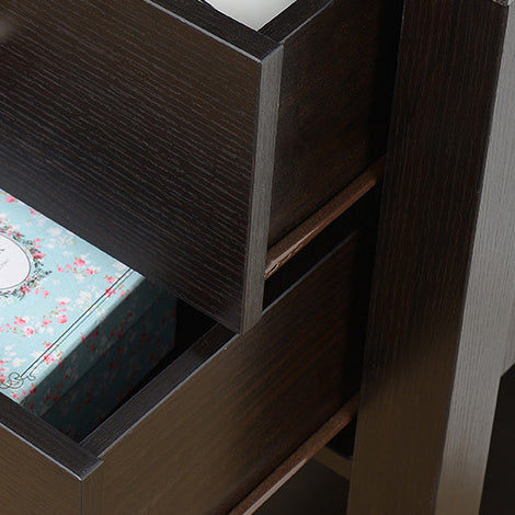 Dark wood bedside table with one open drawer revealing a floral patterned box