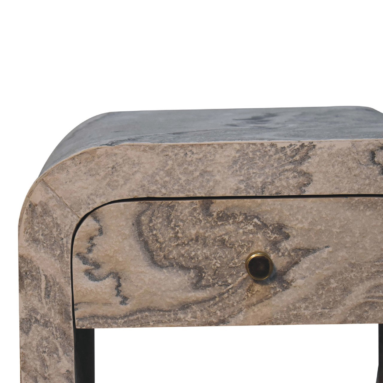 Closeup of a stone console table with a curved edge and single drawer
