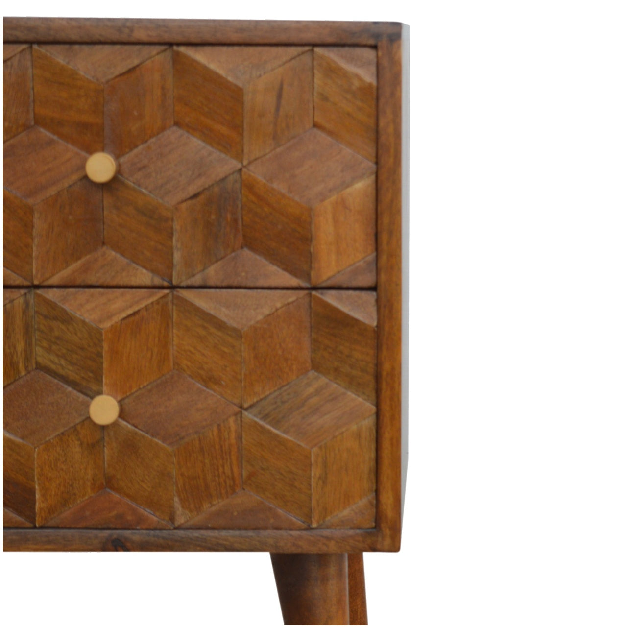 Closeup of a carved wood nightstand with geometric D cube pattern and brass knob