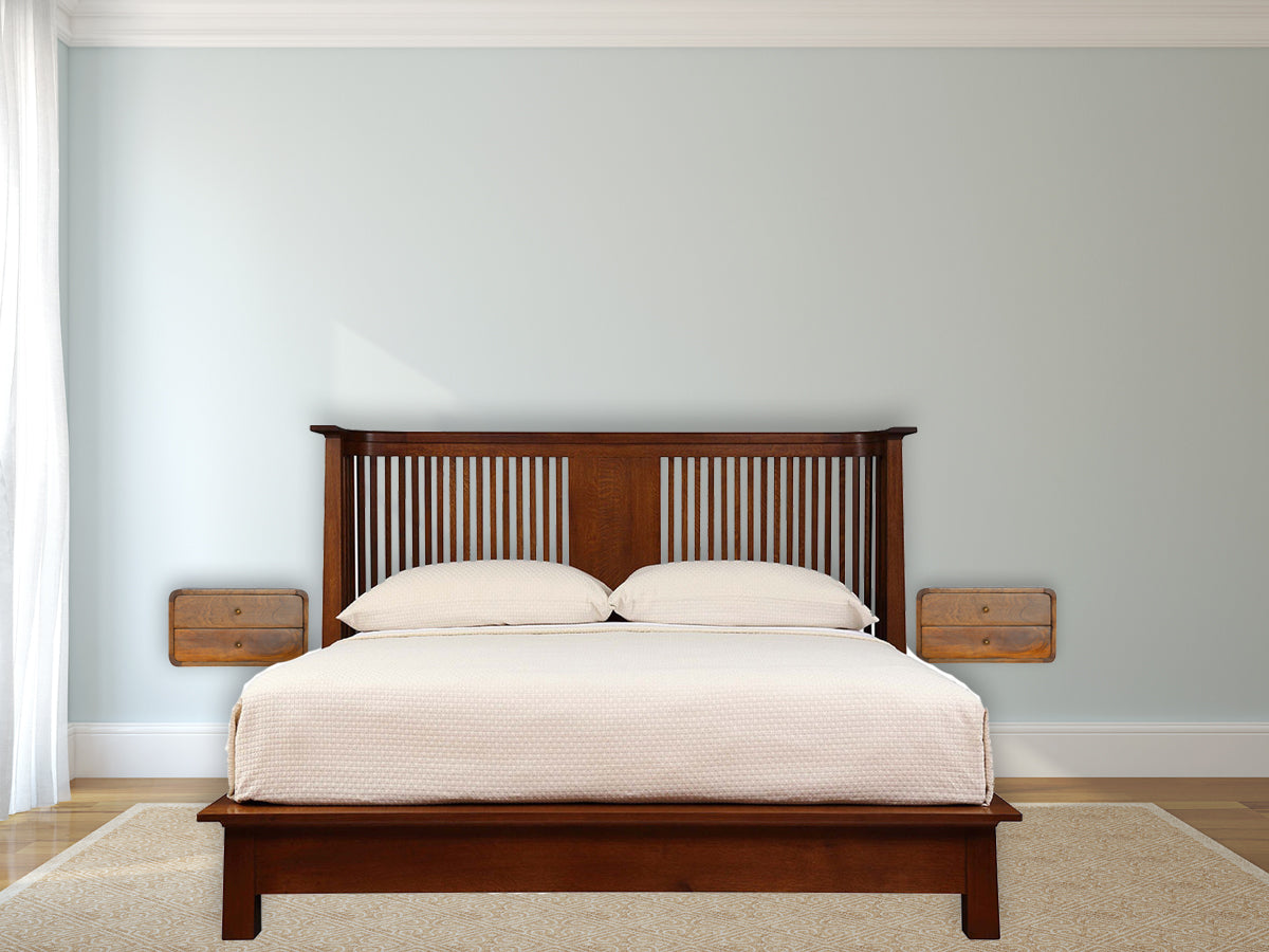 Mission style wooden bed frame with slatted headboard and two cream pillows